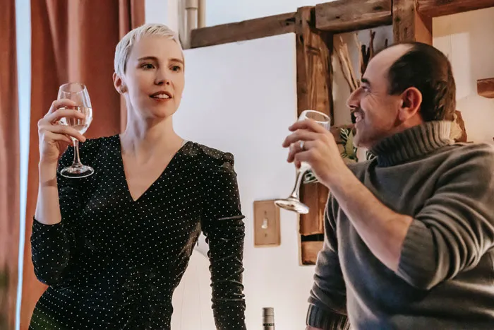 woman and man speaking and drinking wine
