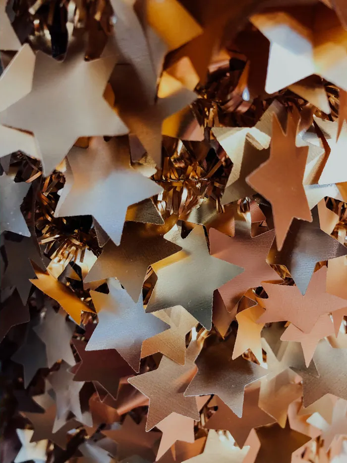 Golden star decorations for New Year’s Eve celebrations, creating a festive atmosphere.