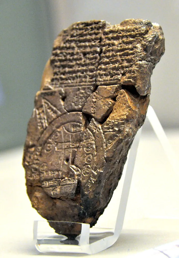 Ancient artifact with cuneiform script on display, revealing important historical information.