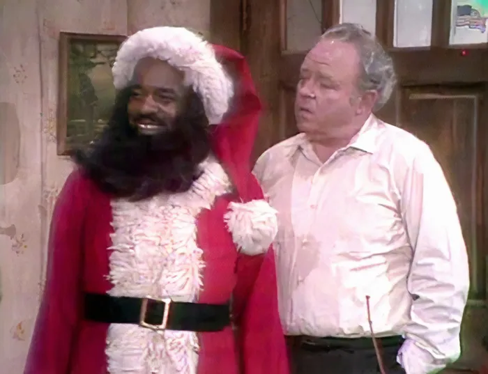 Henry dressed as Santa standing next to Archie 