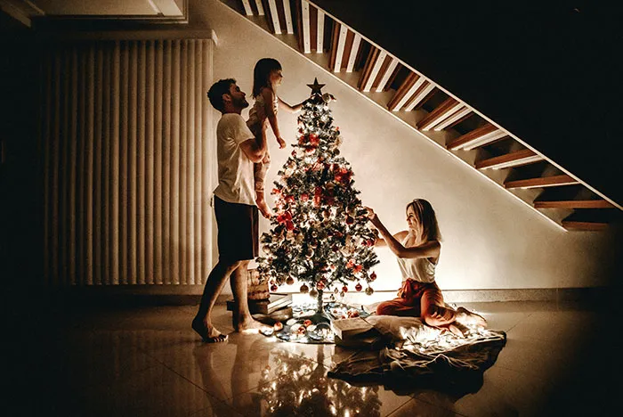 Family decorating Christmas tree together