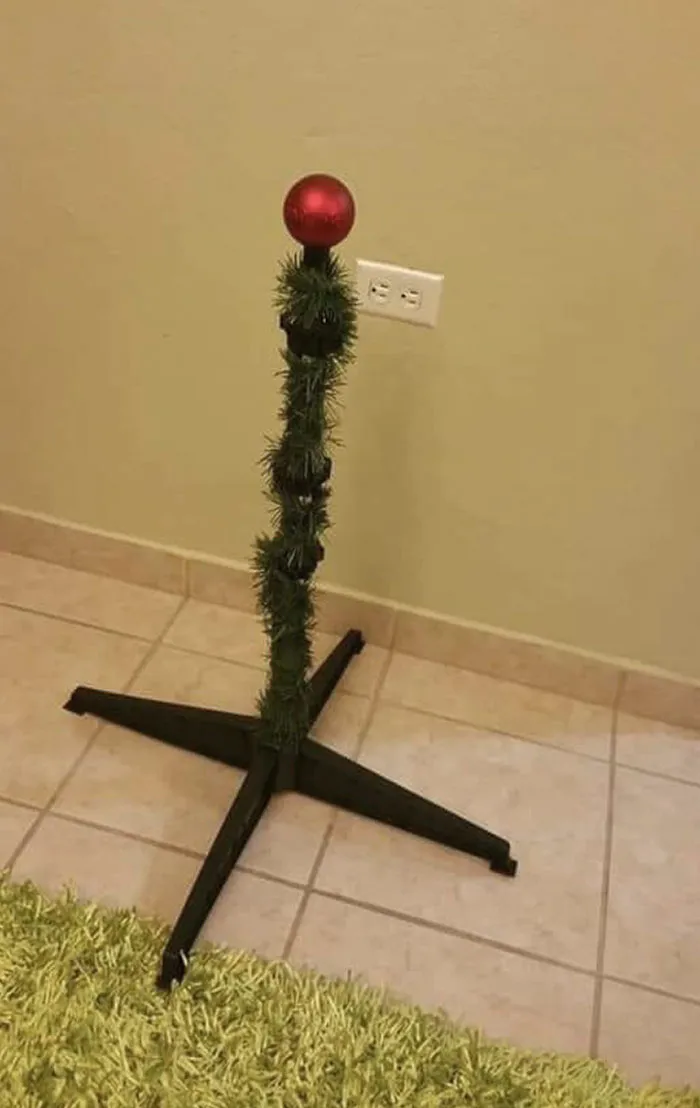 Creative Christmas humor with a minimalistic tree and a single red ornament.