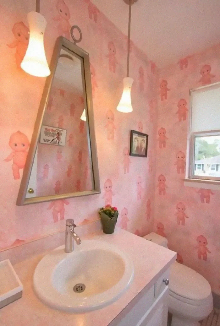 I Wish It Were The Wallpaper That Bugged Me The Most - But Nope, It's That Weird Trapezoid Mirror That Has Nothing In Common With Any Other Theme In This Room
