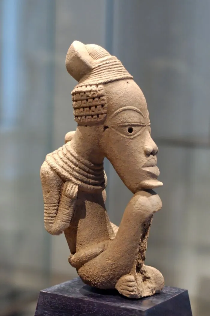 Ancient artifact sculpture with distinct features, providing historical insights.