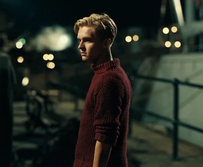 Collins wearing red sweater 