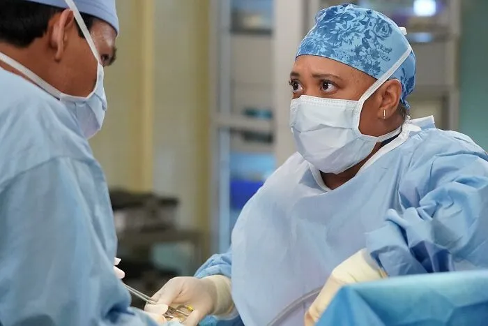 Grey's Anatomy characters wearing surgery clothes