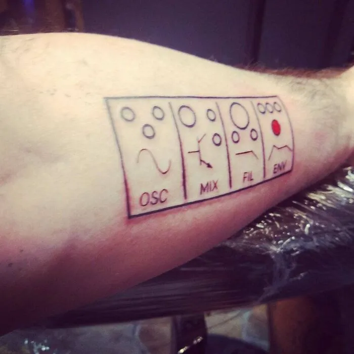 Minimalist tattoo of synthesizer controls with labels OSC, MIX, FIL, and ENV on forearm.