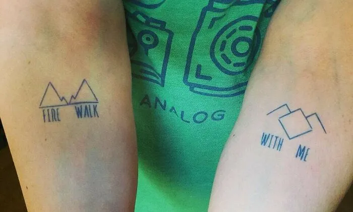 Two minimalist tattoos with geometric designs on forearms, featuring the phrases "Fire Walk" and "With Me."