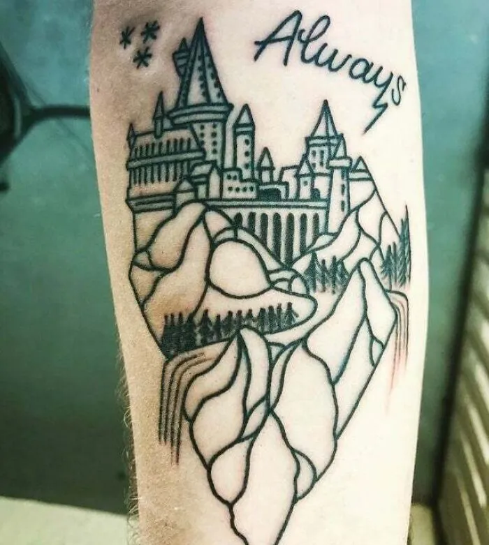 Minimalist castle and forest tattoo featuring "Always" text, designed on an arm for an aesthetically pleasing look.