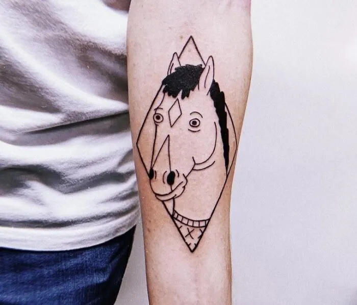 Minimalist tattoo of a geometric horse design on a forearm, featuring simple black lines and shading.