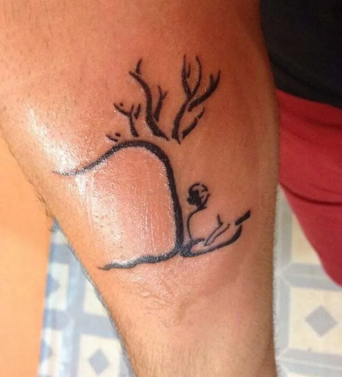 Minimalist tattoo featuring a simple line art design on an arm, blending natural elements with abstract shapes.