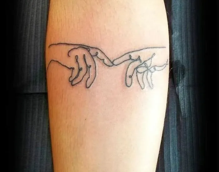 Fine-line single-line tattoo of two hands touching on forearm.