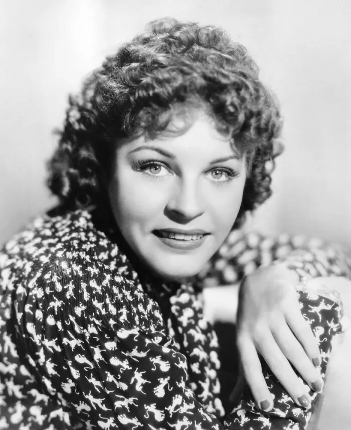 Martha Raye smiling in a patterned blouse, representing famous people who got married multiple times in Hollywood history.