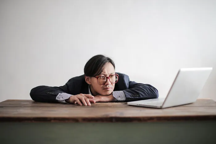 Confused man looking at computer screen 