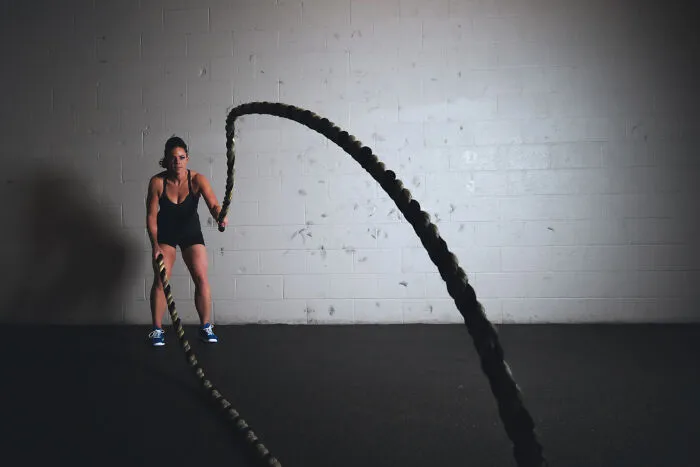 Woman using ropes in the gym 