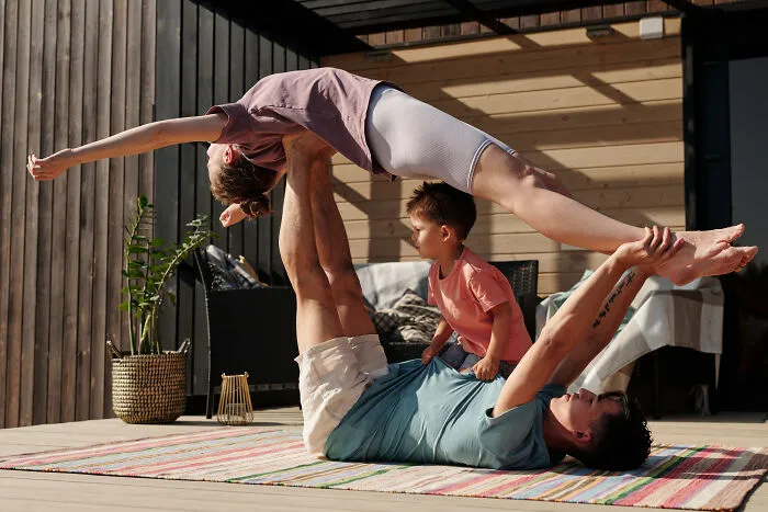 Man and woman doing exercise with a kid 