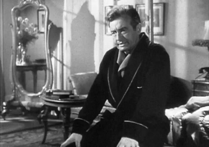 Claude Rains in a robe sitting in a vintage room scene from the Notorious movie, related to famous people married multiple times.