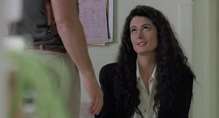 Mel Harris in K-9 movie, wearing a black jacket, representing famous people who got married multiple times.