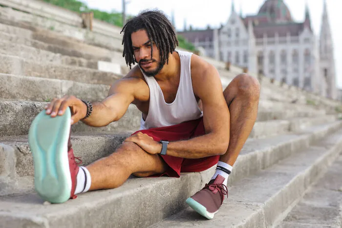 Man stretching on the stairs 