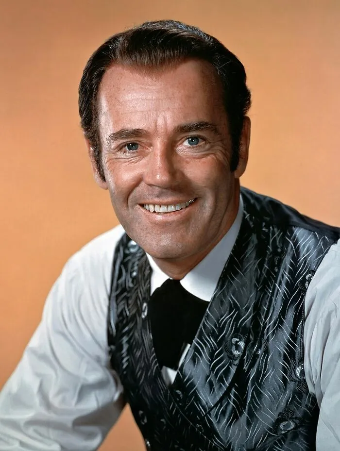 Henry Fonda wearing white shirt and patterned vest, smiling in a classic portrait of famous people married multiple times.