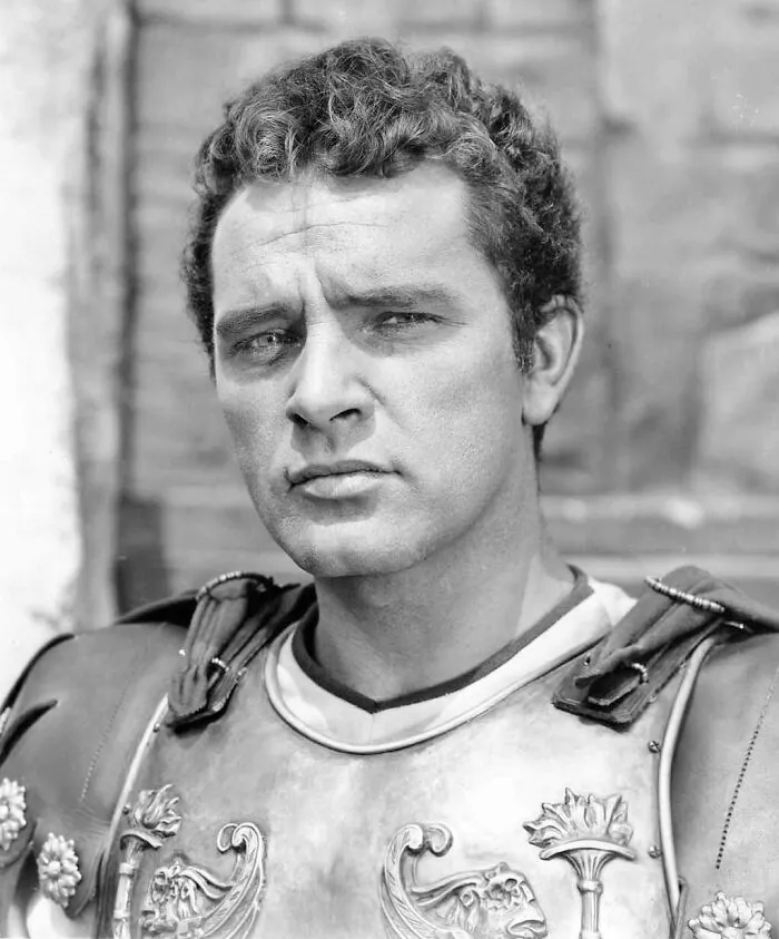 Richard Burton wearing armor in a classic film scene, a notable figure among famous people who got married multiple times.