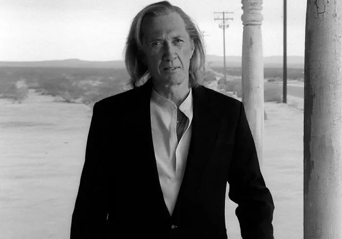 David Carradine in a black jacket from Kill Bill Vol 2, representing famous people who got married multiple times.