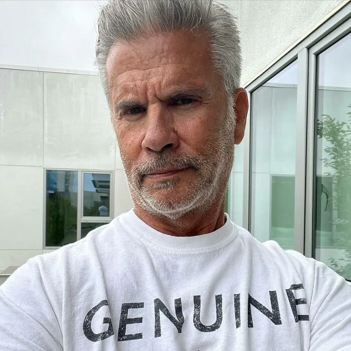 Lorenzo Lamas with bristle wearing a white shirt, featured among famous people who got married multiple times.