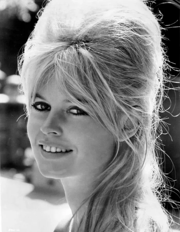 Brigitte Bardot smiling in a black and white portrait, one of the famous people who got married multiple times