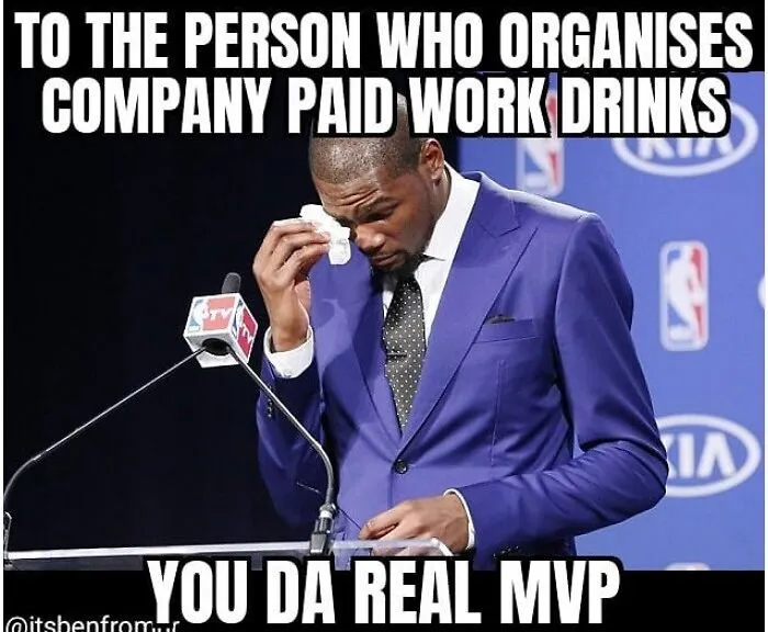 A man in a blue suit on stage, wiping his face humorously, representing a typical HR person's thanks.