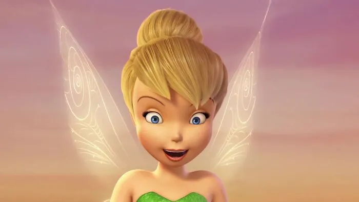 Blonde female cartoon character with wings, smiling against a sunset background, representing fame and strength.