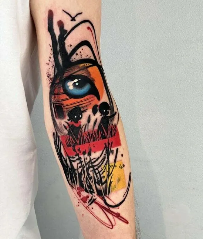 Trippy tattoo featuring an abstract eye and surreal design elements on a person's forearm.