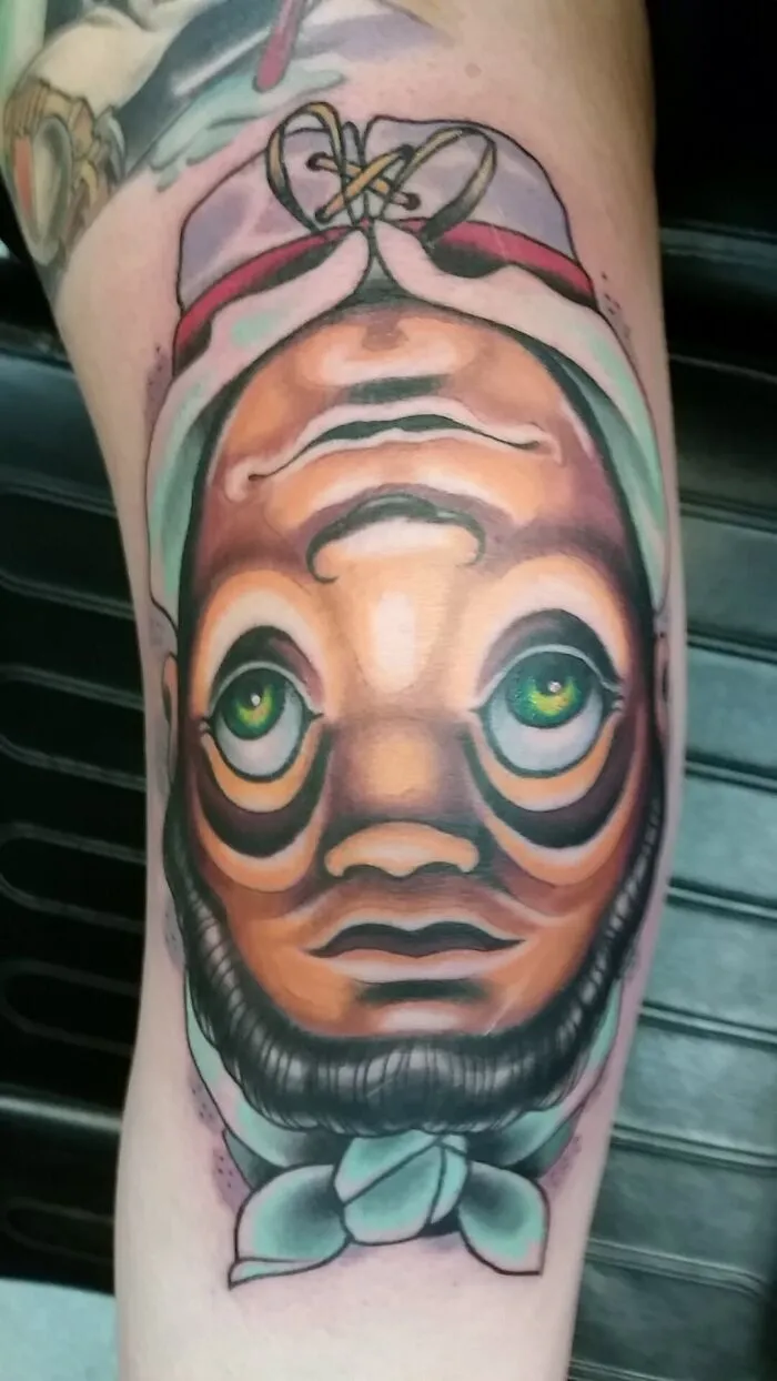 Optical illusion tattoo with a vibrant, eye-bending face design showcasing intricate details and vivid colors.