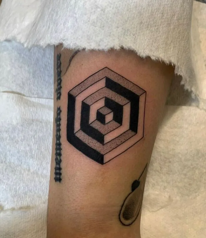 Optical illusion tattoo with geometric hexagon design, creating a mind-bending visual effect.
