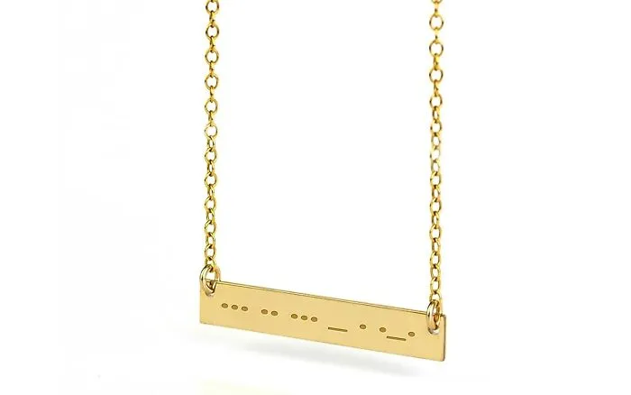 Gold necklace with a rectangular pendant, designed as a Valentine's Day gift to express love and affection.