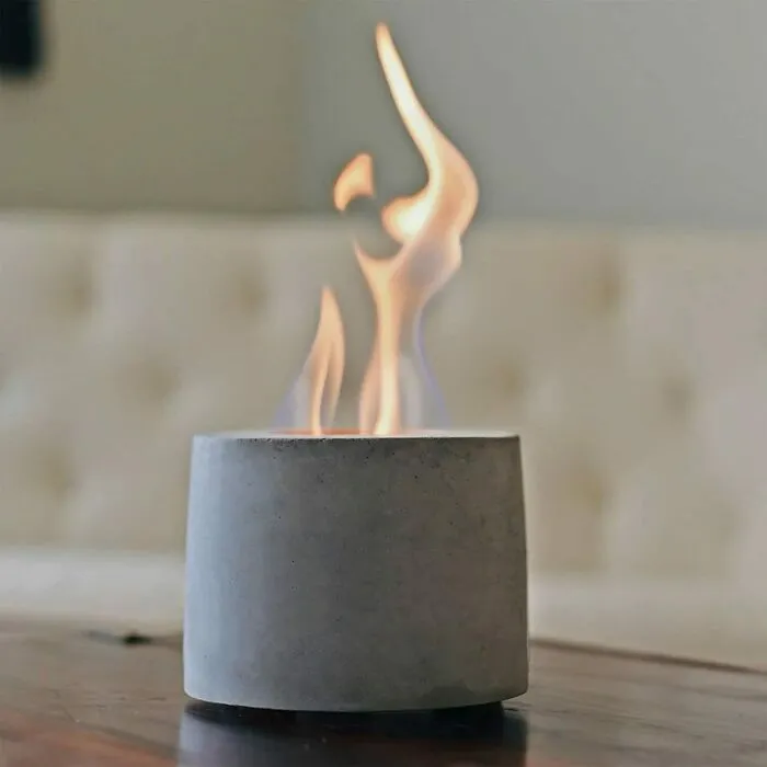 Tabletop fire pit, a cozy Valentine's gift, on a wooden table with soft flames.