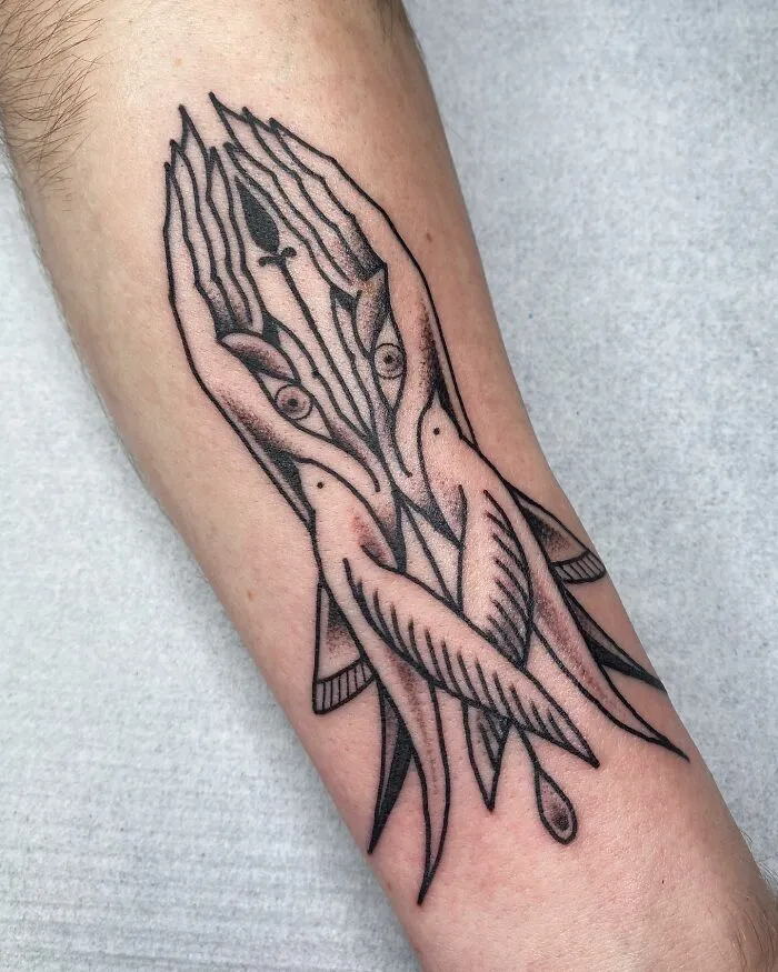 Optical illusion tattoo on arm featuring intertwined hands and fish, creating a mind-bending design.