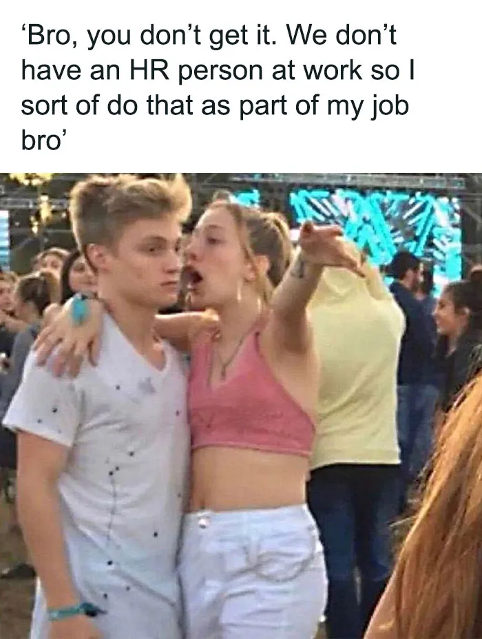 Woman animatedly explains something to a guy at an outdoor event, captioned with a humorous HR meme.