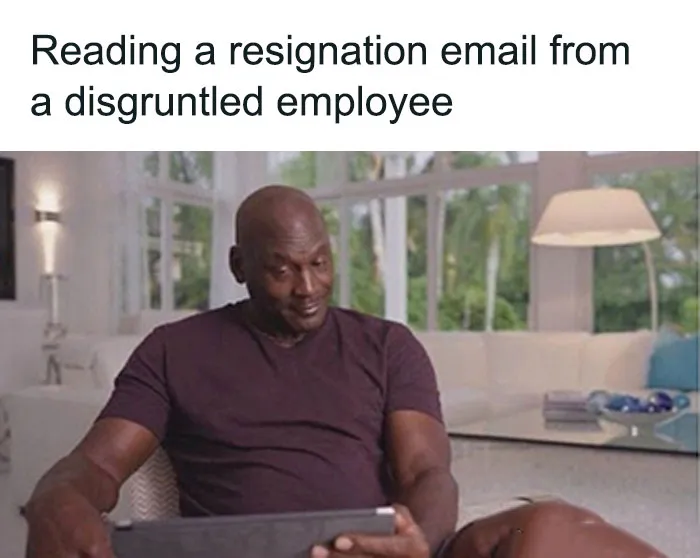 A person reading an office email with a humorous expression, showcasing typical HR meme humor.