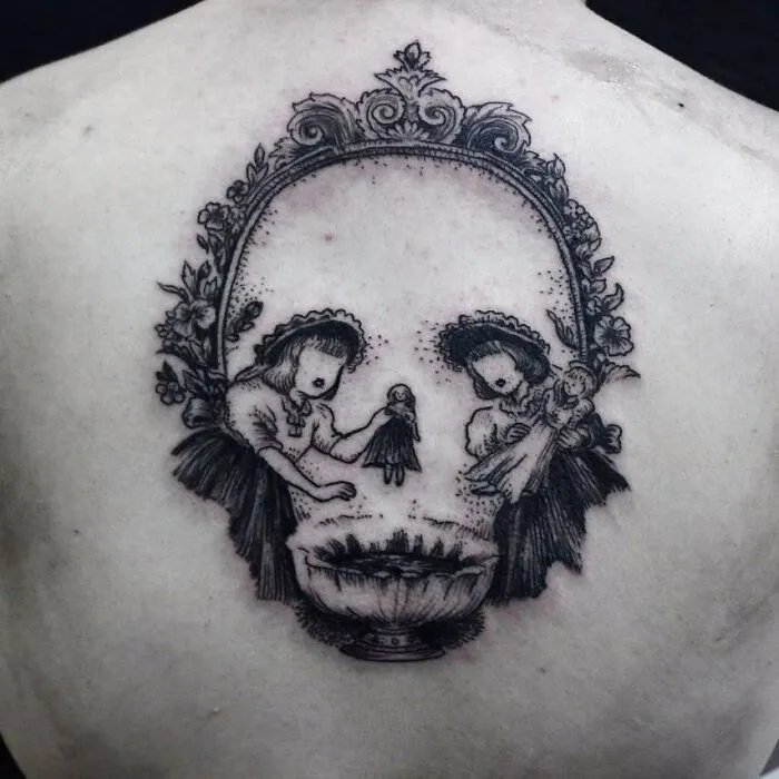Two girls create an optical illusion tattoo, forming a skull with intricate floral details.