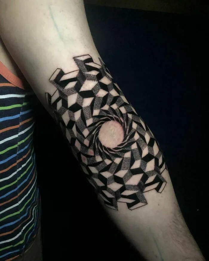 Optical illusion tattoo design on arm with geometric pattern creating a 3D swirl effect.