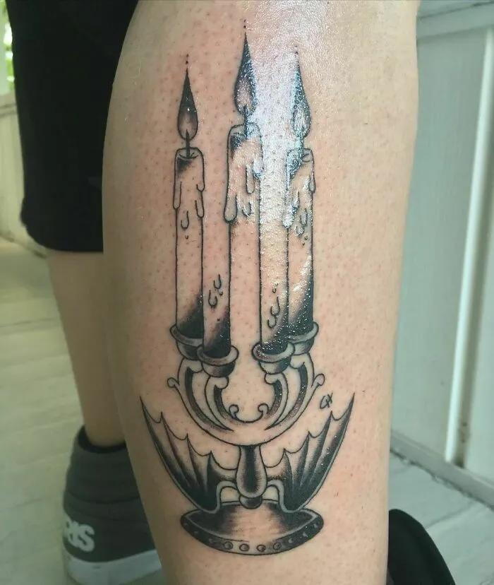 Optical illusion tattoo design of melting candles on a candelabra, creating a mind-bending visual effect.