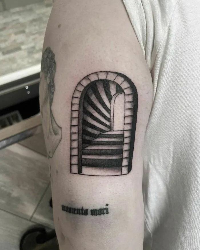 Optical illusion tattoo of a 3D staircase on arm, creating a mind-bending visual effect.