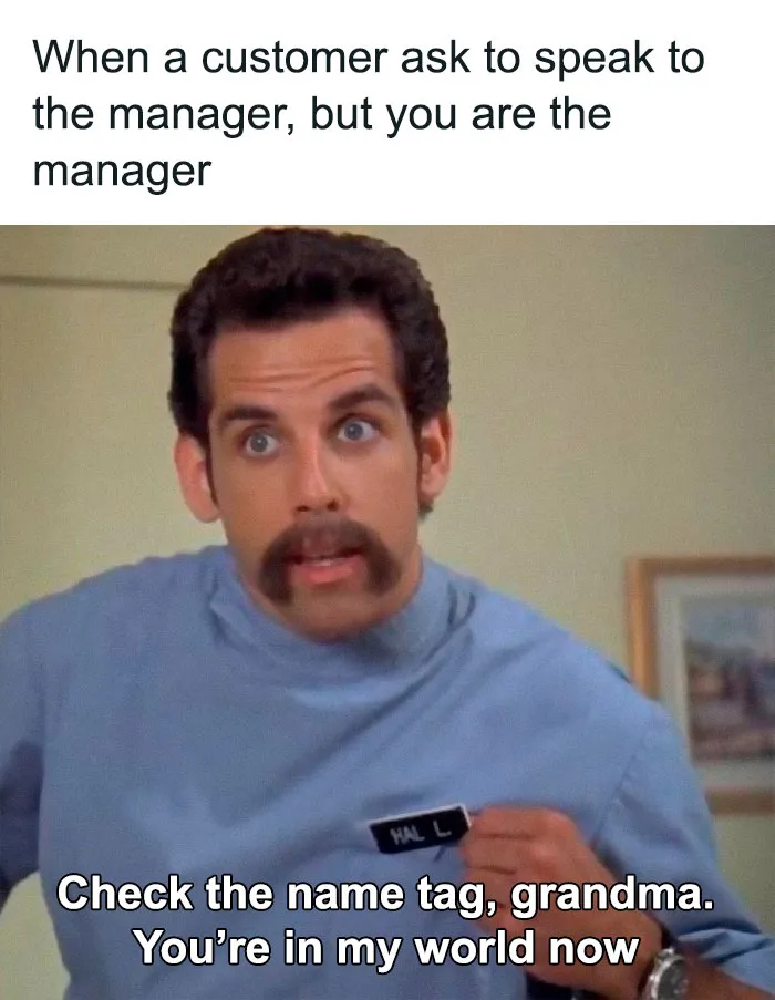 Man with a mustache pointing at name tag, highlighting a relatable work week meme about being mistaken for staff.