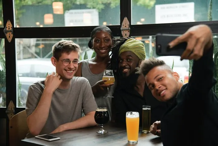 Friends posing For A Picture In A Bar 