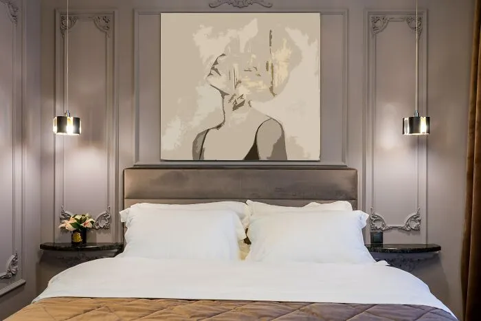 Clean Bedroom With Big Painting Above Bed 