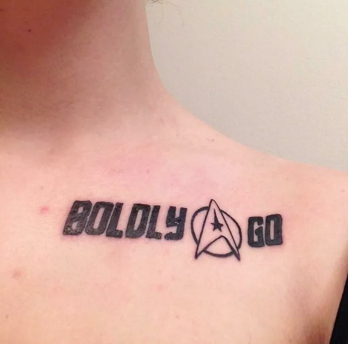 Chest tattoo featuring the words "Boldly Go" with a star emblem, exemplifying creative word tattoos.