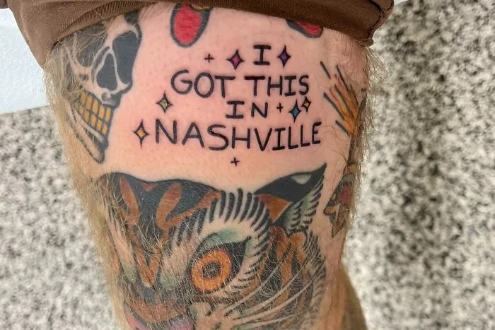 Tattoo featuring the words "I got this in Nashville" with colorful designs, expressing personal connection through body art.