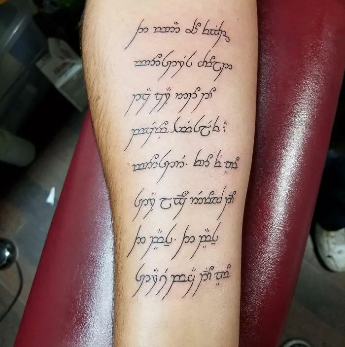 Leg with a creative word tattoo in an elegant script, showcasing artistic inkspiration.