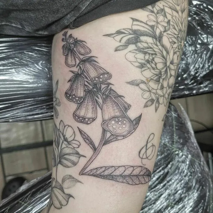 Nature tattoo featuring detailed foxglove flowers on forearm, symbolizing beauty and the wonders of Mother Earth.
