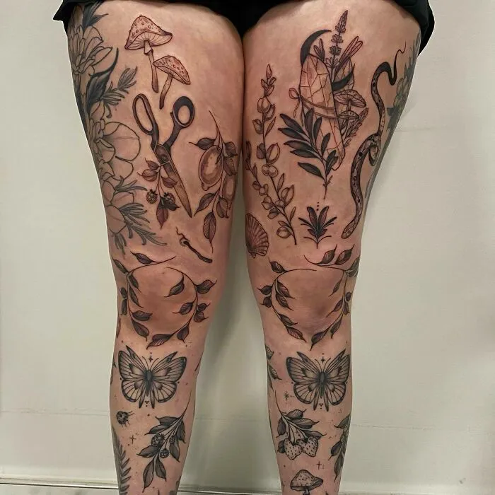Nature-themed tattoos featuring leaves, butterflies, mushrooms, and scissors on legs, celebrating Mother Earth's wonders.